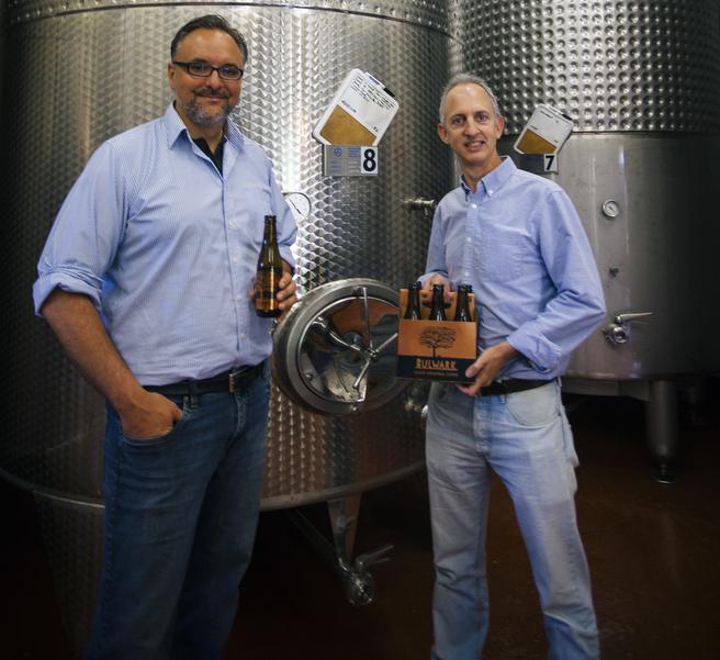Co-founders Dominic Rivard and Germain Bergeron of Muwin Estate Wines Ltd., producers of Bulwark Traditional Craft Cider, stand in front of crates of apples used to make their award-winning ciders. (Contributed)