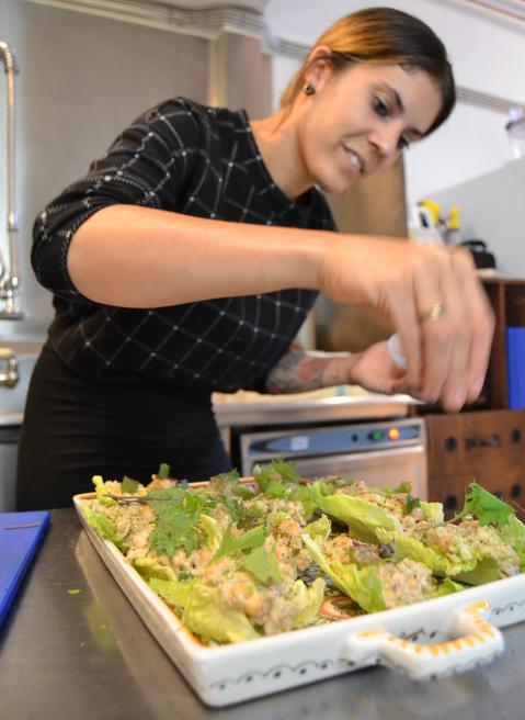 EnVie co-owner Diandra Phipps seasons her restaurant’s creamy chickpea and quinoa salad wraps. When you order this off their menu, EnVie donates $1 from each sale to the Mealshare program, which goes to fund healthy eating programs across Nova Scotia. (Chris Muise)