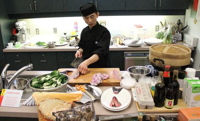 Chef Renyang Zhu from the New Asia Restaurant in the south end demonstrates how to cook three traditional Chinese meals using ingredients that anyone can find at a local grocery store. (Ben Cousins photo)